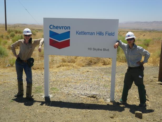 Figure 2. Two former undergraduate research students – Alice Newman ’11 and Amanda Yourd ’11 – braved excessive heat and likely exposure to valley fever during our summer field season in central California. Note the snake chaps and hard hats, required for safety by Chevron, which do not help one stay cool in August. Incidentally, I would like to get back into Kettleman Hills for more field work. If you work at Chevron or know someone who might help me gain access, please send me an email.