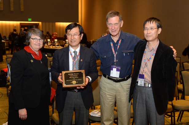 Dr. Shuwen Dong (2nd from the left) proudly displaying GSA IS Honorary Fellow Plaque