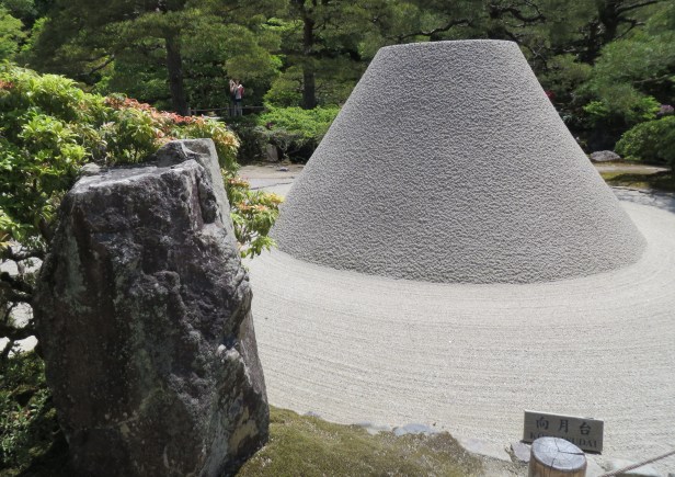 Ginkaku-ji Temple Zen monks rake and sculpture the granitic sand (from the nearby mountain) in shape of Mt Fuji, a mysterious artform.