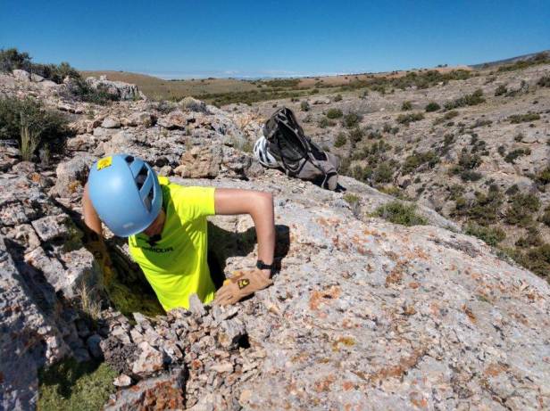 Penelope Vorster, US Forest Service, Custer Gallatin National Forest, Squeezing out of a tight karst feature in the Pryor Mountains, 2019. 