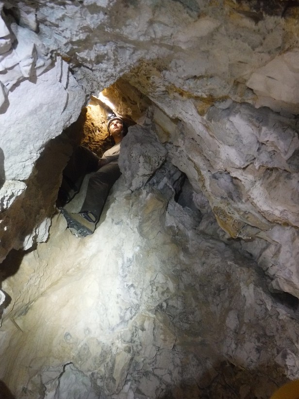 Penelope Vorster, USFS, Custer Gallatin NF, Setting a survey station in a high passage of a newly found cave, 2019. 