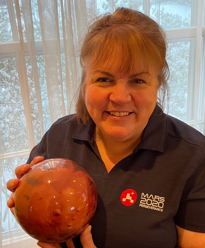 Kathy in official Mars 2020 team shirt, with Mars model disguised as a bowling ball.
